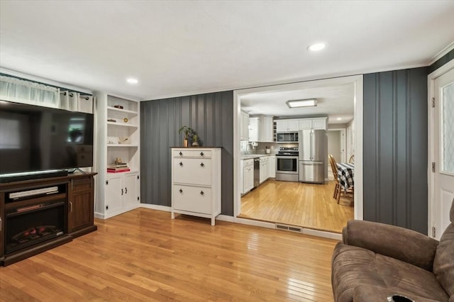 24 S Loomis St, Southwick, MA 01077 - living room featuring light wood-style floors and ornamental molding