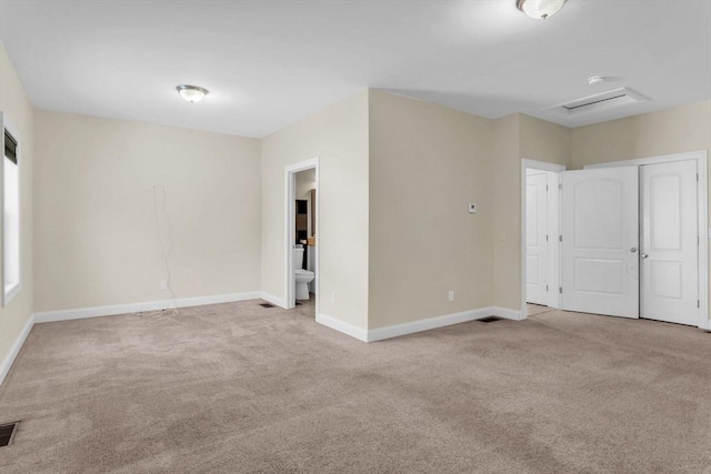 unfurnished room featuring light carpet