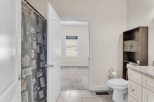 bathroom featuring vanity, tile patterned floors, and toilet