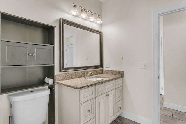 bathroom with vanity, tile patterned floors, and toilet