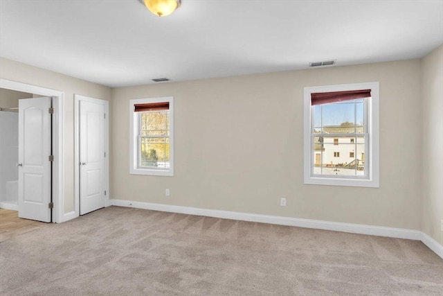 unfurnished bedroom with light colored carpet