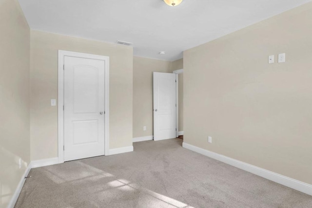 unfurnished bedroom with light colored carpet