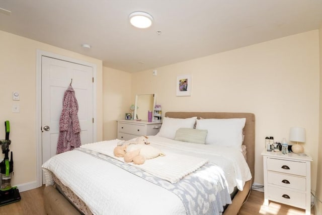 bedroom with wood finished floors and baseboards