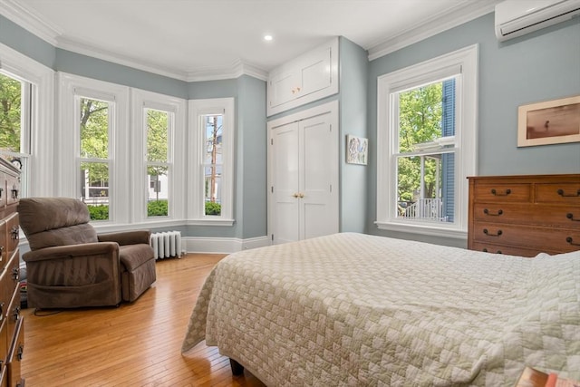 14 Grand View Ave, Somerville, MA 02143 - bedroom with a wall unit AC, light wood-style floors, radiator heating unit, baseboards, and recessed lighting