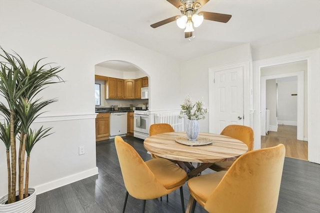 14 Grand View Ave, Somerville, MA 02143 - dining room with dark wood-type flooring, a ceiling fan, baseboards, and arched walkways