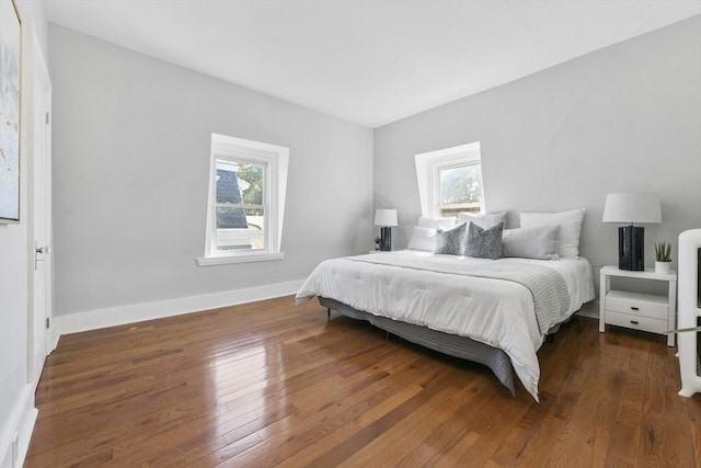 14 Grand View Ave, Somerville, MA 02143 - bedroom with multiple windows, wood finished floors, and baseboards