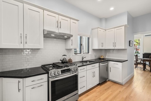 14 Grand View Ave, Somerville, MA 02143 - kitchen featuring appliances with stainless steel finishes, under cabinet range hood, a sink, white cabinetry, and light wood-type flooring