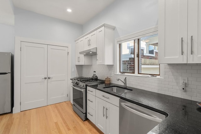 14 Grand View Ave, Somerville, MA 02143 - kitchen featuring stainless steel appliances, a sink, under cabinet range hood, tasteful backsplash, and recessed lighting