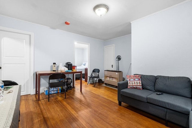 living room with wood-type flooring and crown molding