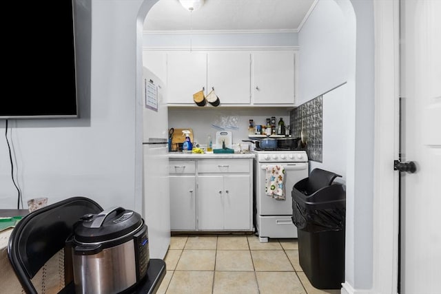 kitchen featuring light tile patterned floors, white appliances, white cabinetry, and ornamental molding