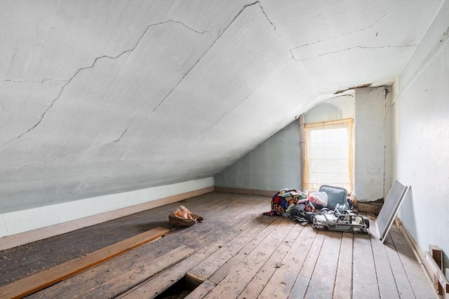 bonus room with lofted ceiling and hardwood / wood-style flooring