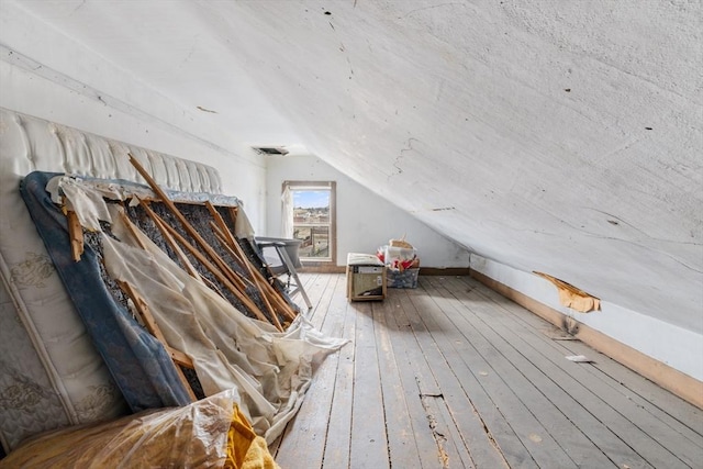 bonus room featuring vaulted ceiling and hardwood / wood-style floors