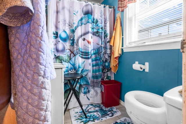 bathroom with toilet and tile patterned floors