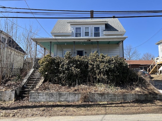 bungalow-style house with a porch, stairway, and a shingled roof