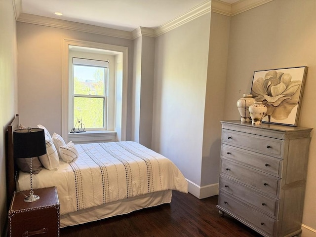 bedroom featuring dark wood-style flooring, baseboards, and ornamental molding
