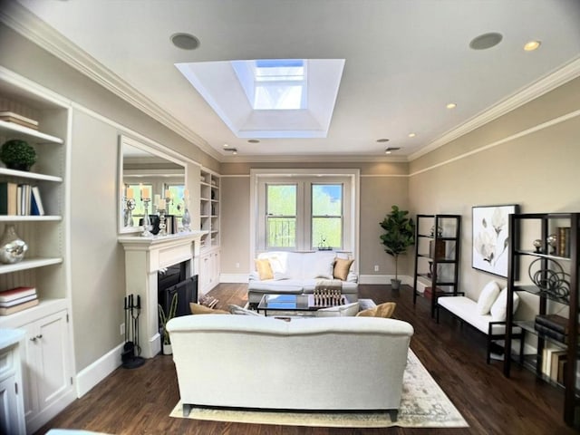living area featuring a skylight, dark wood-type flooring, a fireplace, baseboards, and ornamental molding