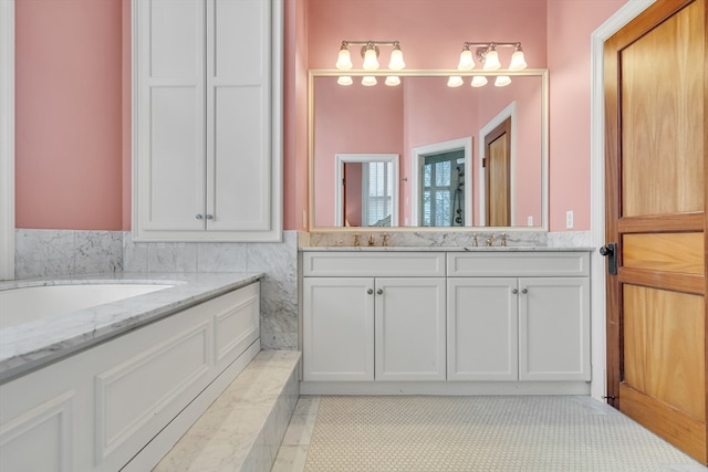 bathroom with tile flooring, a bath to relax in, and vanity