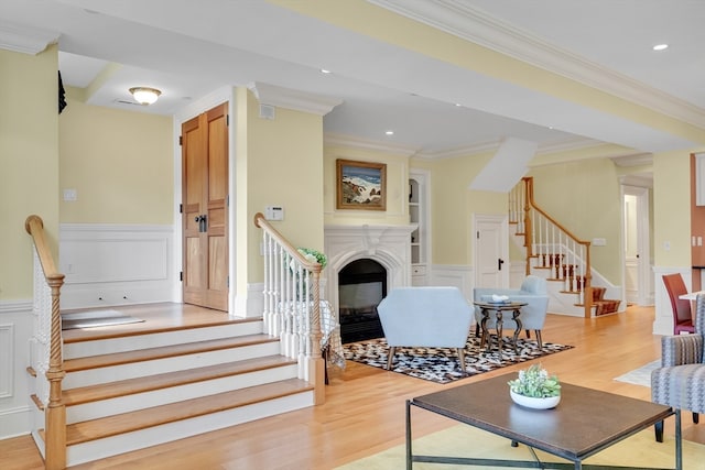 interior space with light hardwood / wood-style floors and ornamental molding