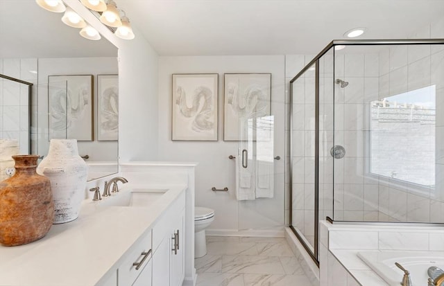 full bathroom featuring vanity, toilet, and separate shower and tub