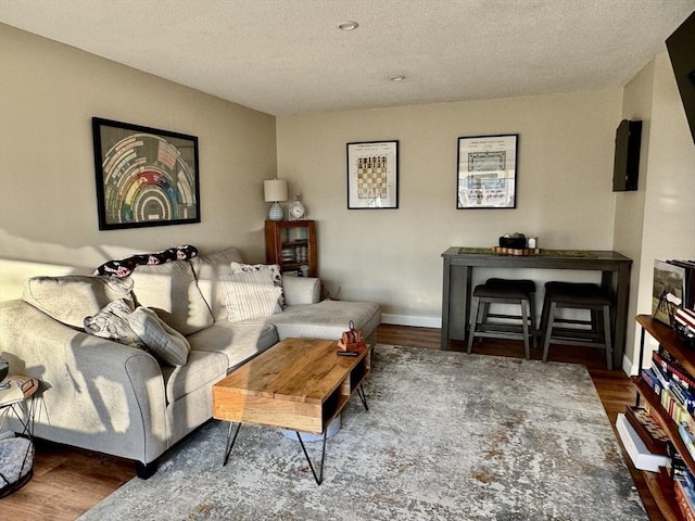 living room featuring a textured ceiling and dark hardwood / wood-style floors