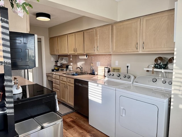 laundry room with washer and clothes dryer, dark wood-type flooring, and sink