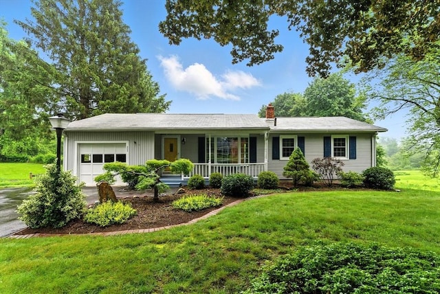 205 Mosier St, South Hadley, MA 01075 - ranch-style home with an attached garage, a porch, a front lawn, and a chimney