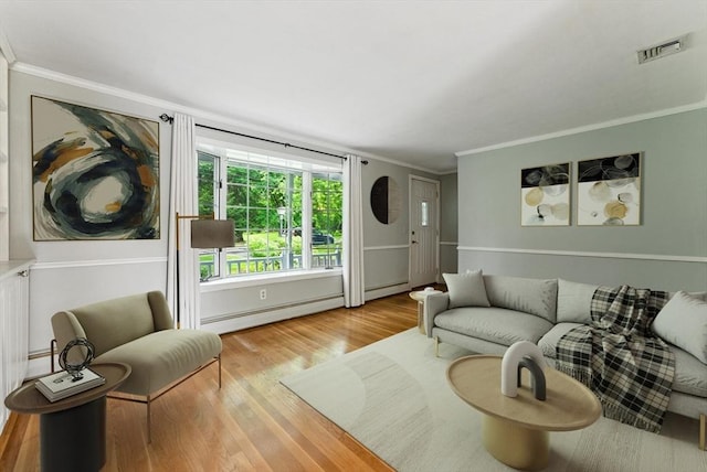 205 Mosier St, South Hadley, MA 01075 - living room featuring baseboard heating, ornamental molding, and wood finished floors