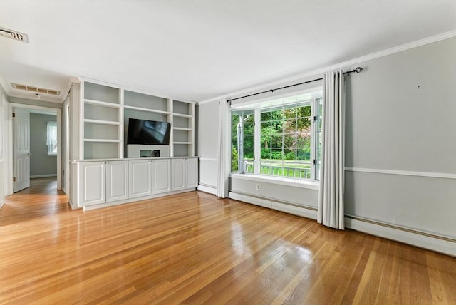205 Mosier St, South Hadley, MA 01075 - unfurnished living room with baseboard heating, ornamental molding, light wood-style floors, and healthy amount of natural light