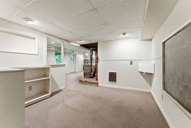 205 Mosier St, South Hadley, MA 01075 - below grade area with a wood stove, a paneled ceiling, and carpet floors