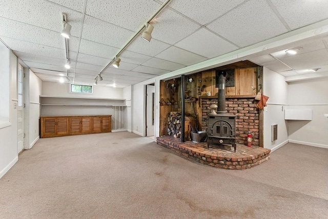 205 Mosier St, South Hadley, MA 01075 - below grade area featuring rail lighting, a wood stove, carpet flooring, and a drop ceiling