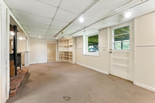 205 Mosier St, South Hadley, MA 01075 - unfurnished living room featuring carpet flooring, track lighting, and a wood stove