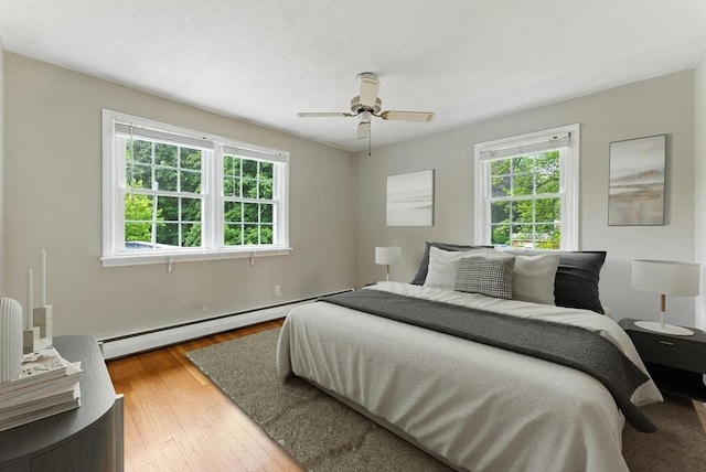 205 Mosier St, South Hadley, MA 01075 - bedroom with multiple windows, a baseboard radiator, hardwood / wood-style flooring, and a ceiling fan