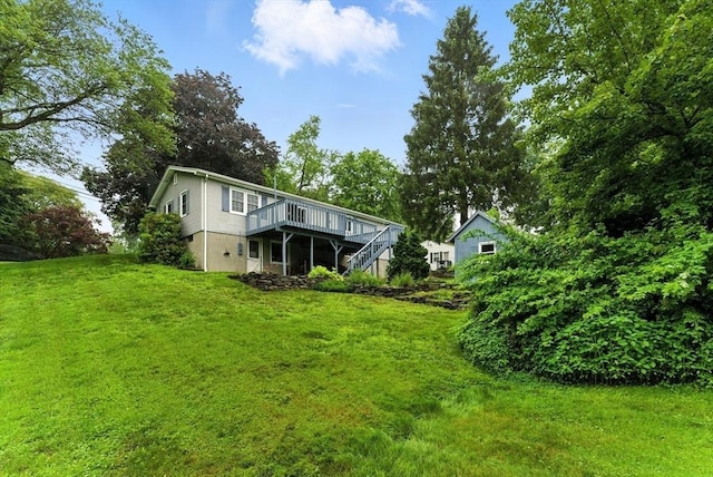205 Mosier St, South Hadley, MA 01075 - back of property featuring a wooden deck, stairs, and a yard