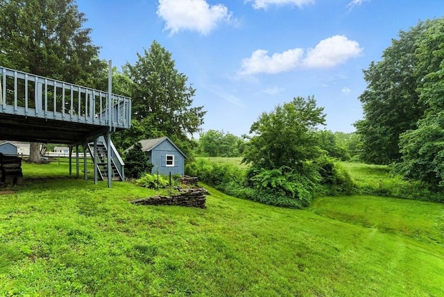 205 Mosier St, South Hadley, MA 01075 - view of grassy yard with stairs, a wooden deck, and a storage unit