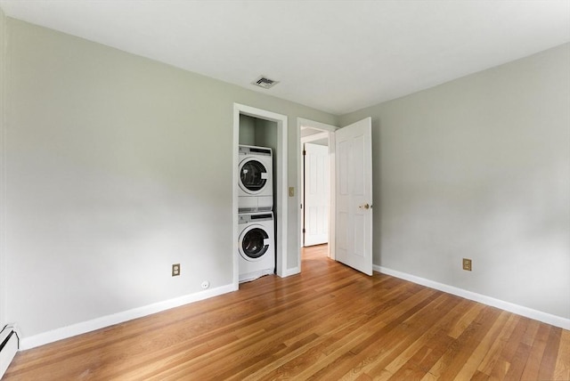 205 Mosier St, South Hadley, MA 01075 - empty room featuring stacked washer / dryer, light wood-type flooring, and baseboard heating