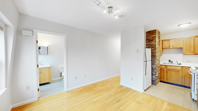 506 E 8th St Unit 3, Boston, MA 02127 - kitchen featuring white appliances, light countertops, a sink, and baseboards