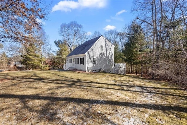 view of side of home with a lawn