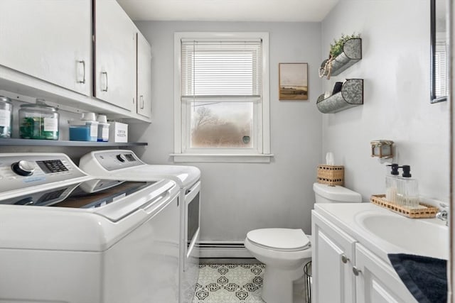 laundry area with tile patterned floors, independent washer and dryer, a sink, a baseboard radiator, and laundry area