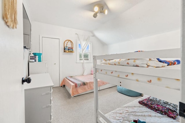 bedroom featuring vaulted ceiling and light carpet