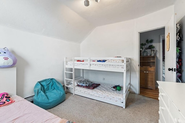 bedroom featuring baseboard heating, carpet, and lofted ceiling