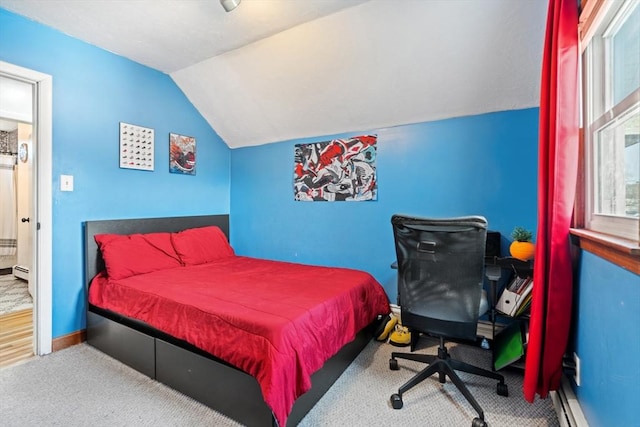 carpeted bedroom featuring baseboards, lofted ceiling, and a baseboard radiator