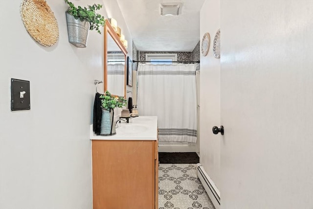 bathroom with vanity, a shower with curtain, visible vents, a baseboard radiator, and tile patterned floors