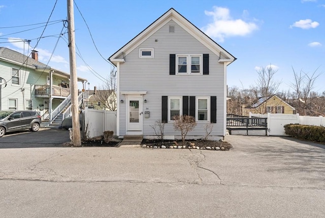 traditional home with entry steps and fence