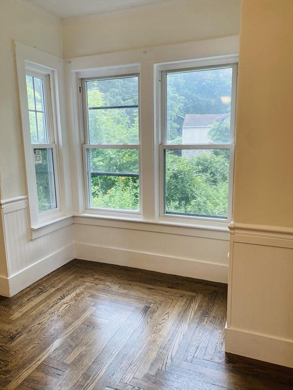 spare room with dark parquet flooring