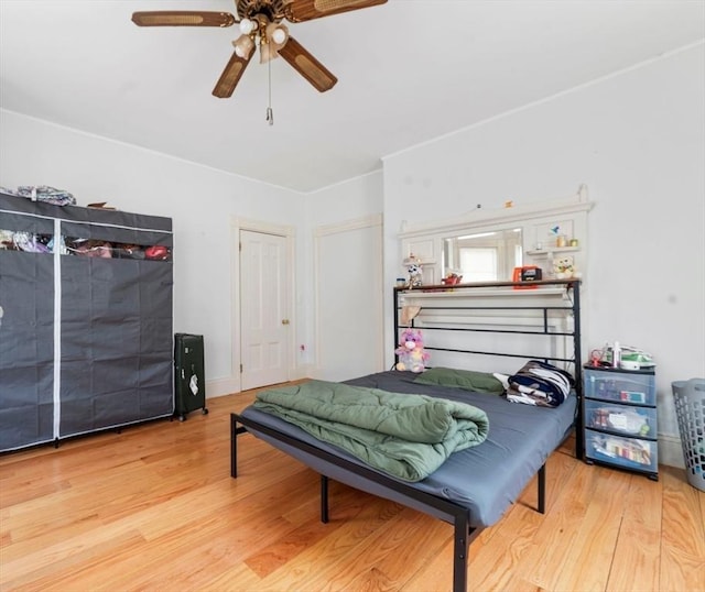 bedroom featuring ceiling fan and wood finished floors