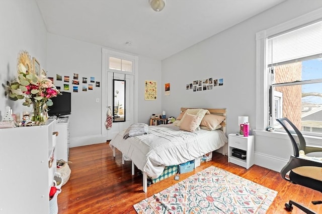 bedroom with wood finished floors and baseboards