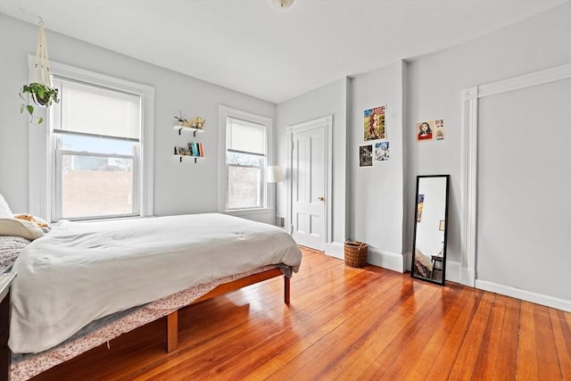 bedroom featuring light wood-style flooring and baseboards