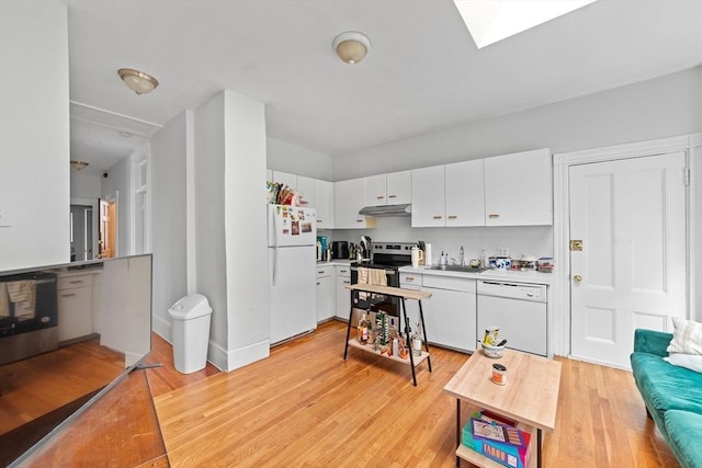 kitchen featuring white appliances, a skylight, light wood-style flooring, and white cabinets