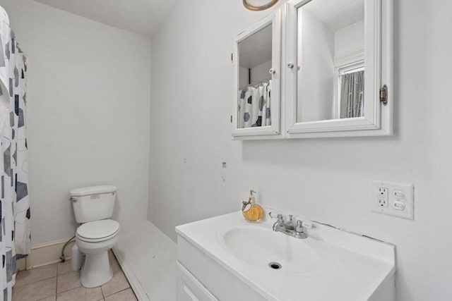 bathroom with vanity, toilet, and tile patterned floors