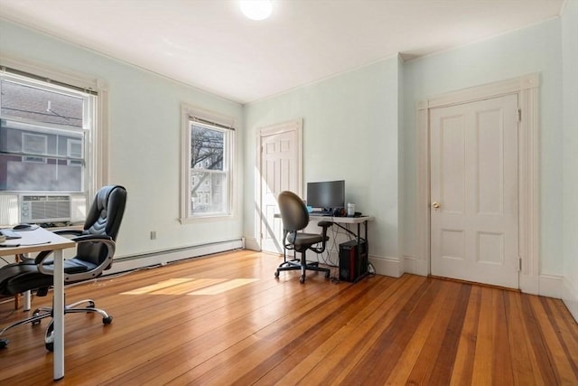 home office featuring a baseboard heating unit, cooling unit, light wood-style floors, and baseboards